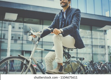 Business Man Riding Bike On Street. Close Up.