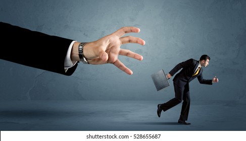 Business Man Running Away From A Huge Hand Concept On Background