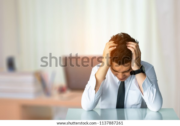 Business man sad\
sitting or strait business man sitting chair Express feeling In\
city blurry background Metaphor for Success finance Dealing buying\
or Insurance image