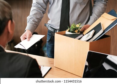 Business Man Sending Resignation Letter To Boss And Holding Stuff Resign Depress Or Carrying Cardboard Box By Desk In Office