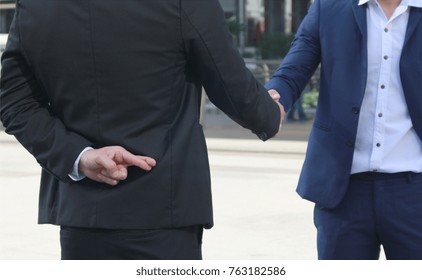 Business man shaking hand with lie sign