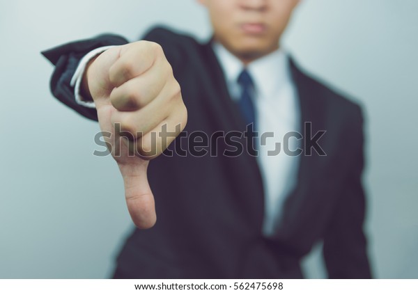Business man  show thumbs
down
