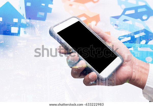 business man showing hand hold smart phone  double\
exposure with city\
light