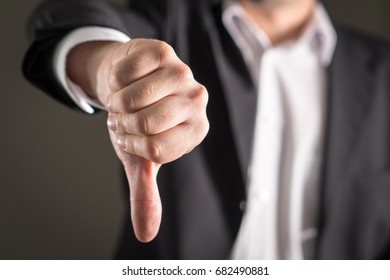 Business Man Showing Thumbs Down.