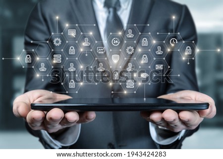 Business man shows structure on tablet on blurred background.