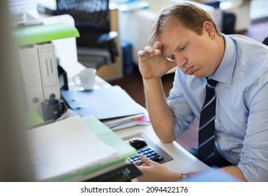 Business Man Sighing At Desk