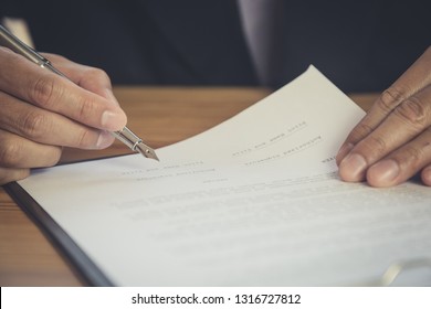 Business Man Signing A Contract. Owns The Business Sign Personally, Director Of The Company, Solicitor. Real Estate Agent Holding House, Financial Or Renting Property, Merger And Acquisition Concept.