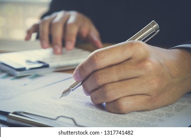 Business Man Signing A Contract. Owns The Business Sign Personally, Director Of The Company, Solicitor. Real Estate Agent Holding House, Financial Or Renting Property, Merger And Acquisition Concept.