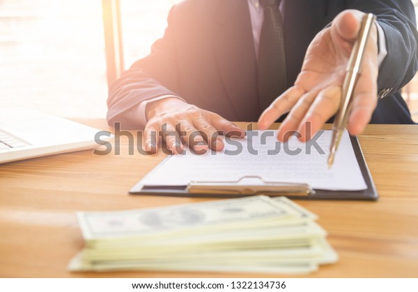 Business man signing a contract. Owns the\
business sign personally, director of the company, solicitor. Real\
estate agent holding house, financial or renting property, merger\
and acquisition\
concept.