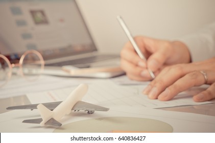 Business man is signing documents for his Business travel trip, Travel agency officer is reserving tickets for customer online. Business global communication concept.