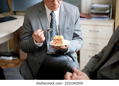 Business Man Sitting At The Desk And Eating Honey Cake, Coffee Break In Office