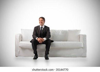 Business Man Sitting On A White Modern Sofa