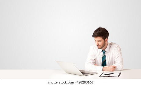 Business Man Sitting At White Table With A White Laptop On White Background