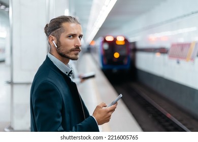 Business Man With A Smartphone Standing On The Subway Platform.