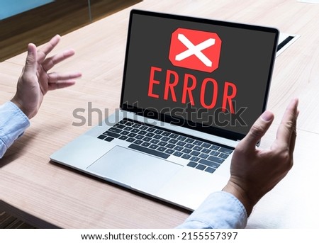 Business man spread out your hands with icon and message ERROR on display laptop