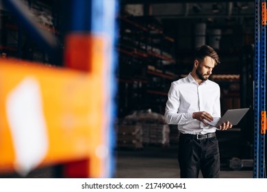 Business Man Standing At The Factory And Using Laptop