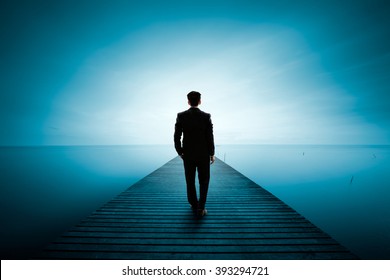 Business man standing on wooden bridge and looks at the sea, Business concept - Powered by Shutterstock