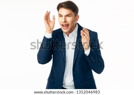 business man in suit emotions gestures with hands light background