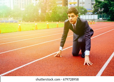 Business Man In Suit Starting And Preparing To Run On The Competition Running Performance Track