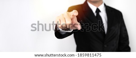 business man in a suit is using his index finger to direct or oppress on white background.