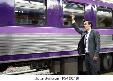 Business Man With Suit Wave Hand  At Subway. Happy Businessman Waving His Hand To Friend On Train And Say Bye Bye. Businessman Smile Greet And Say Hello Friend Colleague While Standing