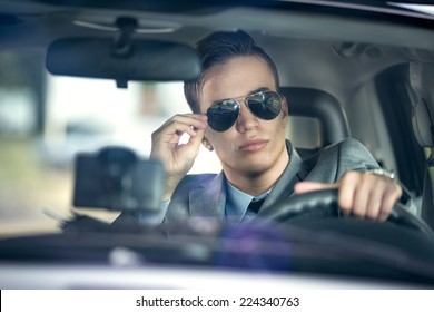 Business Man With Sunglasses  Driving A Car