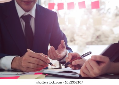 Business man supervising and secretary to execute business plan and consultant analyzing company annual financial report balance sheet statement working with documents graphs. Audit and consultant