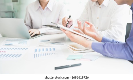 Business man supervising and secretary to execute business plan and consultant analyzing company annual financial report balance sheet statement working with documents graphs. Audit and consultant
