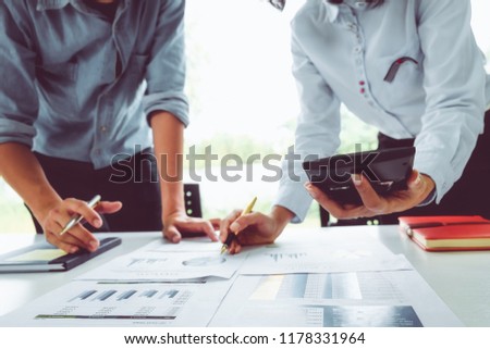 Business man supervising and secretary to execute business plan and consultant analyzing company annual financial report balance sheet statement working with documents graphs. Audit and consultant
