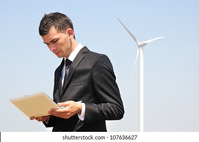 Business Man With Tablet At Wind Farm