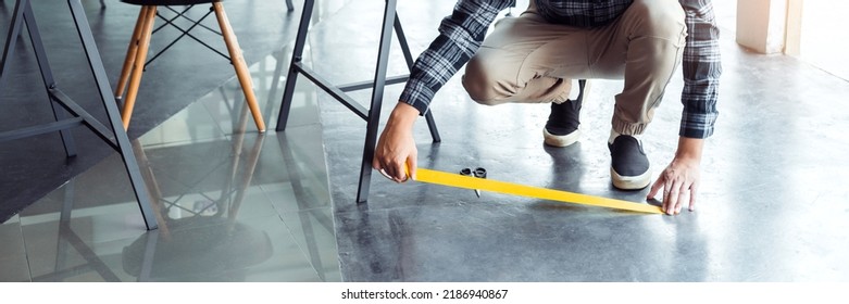 Business Man Tape Being Attached Behind Social Distancing Signage On Office Floor During COVID-19 Pandemic . Social Distancing Concept.