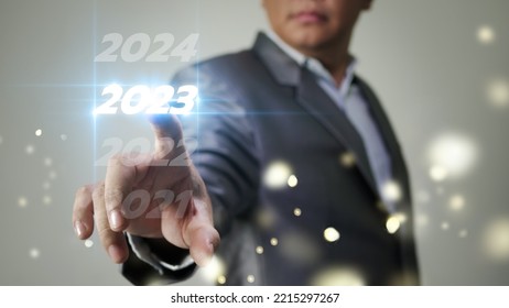 Business Man Taps On Virtual Screen Number 2023 In Preparation For The New Year's Celebration To Boost Business Growth In The New Year.