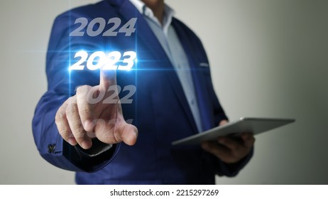 Business Man Taps On Virtual Screen Number 2023 In Preparation For The New Year's Celebration To Boost Business Growth In The New Year.