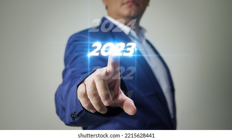 Business Man Taps On Virtual Screen Number 2023 In Preparation For The New Year's Celebration To Boost Business Growth In The New Year.