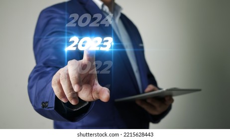 Business Man Taps On Virtual Screen Number 2023 In Preparation For The New Year's Celebration To Boost Business Growth In The New Year.