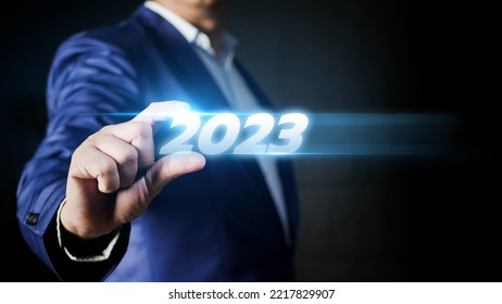 Business Man Taps On Virtual Screen Number 2023 In Preparation For The New Year's Celebration To Boost Business Growth In The New Year.