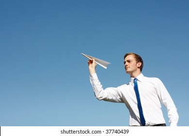 A Business Man Throwing A Paper Plane