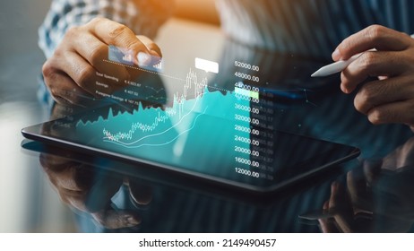 Business man trader investor using tablet analysis for cryptocurrency financial market. Concept for trading fund data index statistic chart graph on laptop screen. - Shutterstock ID 2149490457