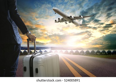 Business Man And Traveling Luggage Standing In Airport Terminal And Passenger Plane Flying Over Sky