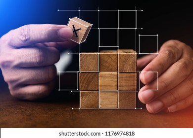 business man try to build wood block on wooden table and blur background business organization startup concept - Shutterstock ID 1176974818