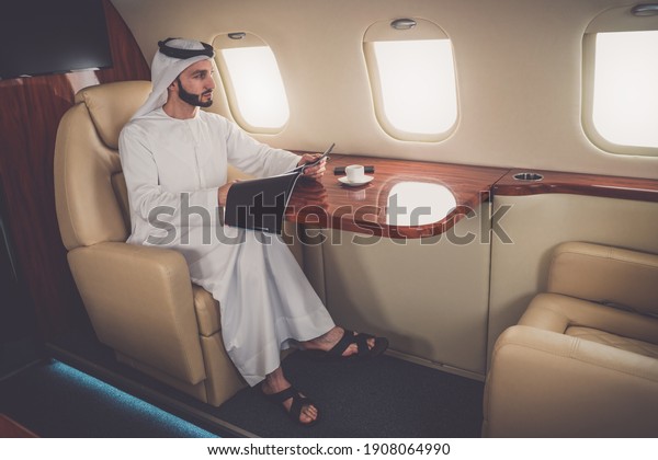 Business man from united arab emirates flying on\
his private jet to\
Dubai