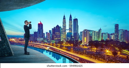 Business Man use the telescope to watch the modern city skyline ,is about looking forward for search key success business concept . - Powered by Shutterstock