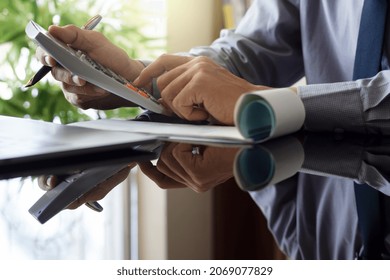 Business Man Using Calculator And Sign Cheque, Work On Laptop Computer At Office. Payment And Payrol Concept. Copy Space.