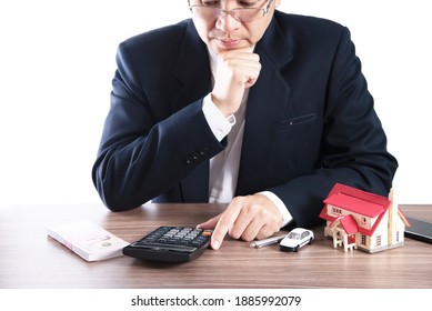 Business Man Is Using Calculator Thinking About Money For House And Car Payment - People With Real Estate Financial Insurance Concept