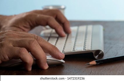 Business man using computer. Man holding mouse on a work desk