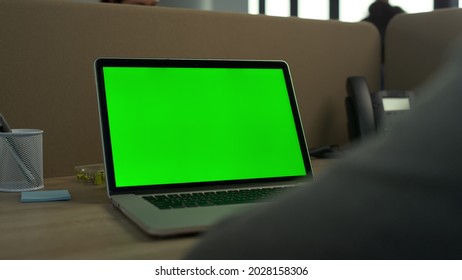 Business Man Using Green Screen Laptop Computer In Office. Green Screen Computer Closeup. Unrecognizable Man Working On Laptop Chroma Key. Closeup Of Computer Greenscreen