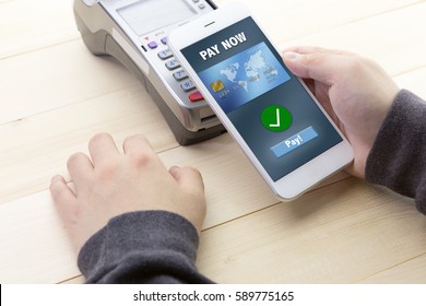 A Business Man Using His Mobile To Made A Payment Wireless With EDC Machine Or Credit Card Terminal. Mobile Payment Concept With Fake Credit Card.