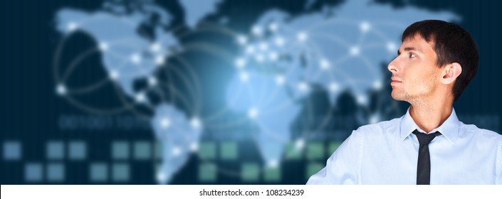 A business man is using the internet. A map of the Earth with glowing points of locations and lines of connections and technology images in the background.