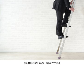 Business man using ladder, step up images - Powered by Shutterstock