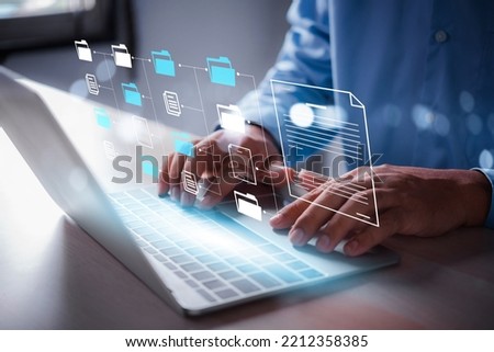 business man using laptop access files document on viritual screen, document management system